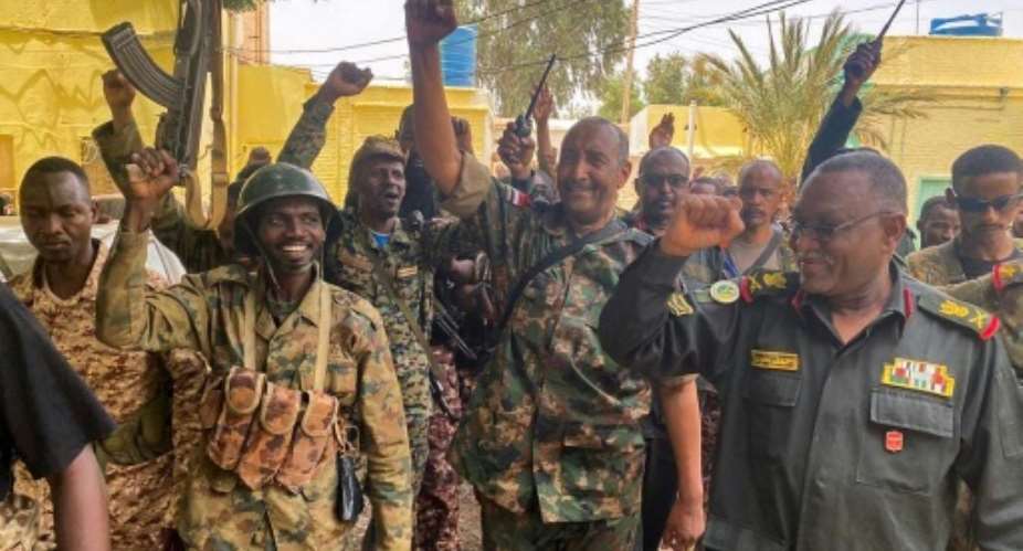 Sudan's army chief Abdel Fattah al-Burhan cheering with soldiers as he visits some of their positions in Khartoum.  By - SUDAN'S ARMED FORCES FACEBOOK PAGEAFP