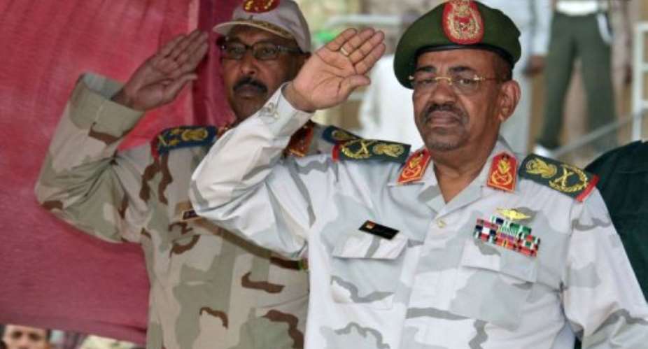 Sudan's President Omar al-Bashir R and Defence Minister Abdelrahim Mohamed Hussein salute.  By Ebrahim Hamid AFP