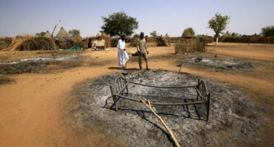 Sudan's Darfur has suffered years of conflict; this photograph from February 2 shows the ruins of a home set on fire in fighting.  By ASHRAF SHAZLY AFP