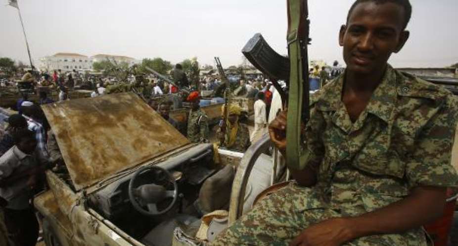 A fighter from the Sudanese Rapid Support Forces sits on a vehicle in the city of Nyala, in south Darfur, on May 3, 2015.  By Ashraf Shazly AFPFile
