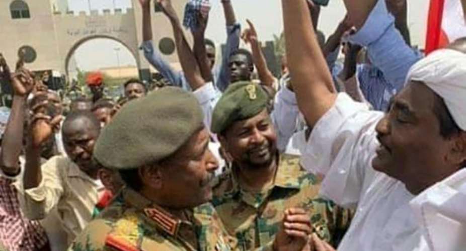 Sudan's second new military ruler in as many days, Lieutenant General Abdel Fattah al-Burhan, is seen talking with protesters outside army headquarters in a photograph released by state news agency SUNA.  By - SUDAN NEWS AGENCYAFP