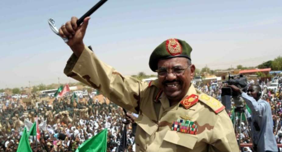 Sudan's toppled president Omar al-Bashir waves to the crowd during an April 2012 visit to the Northern Kordofan town of El-Obeid to address newly-trained paramilitary troops.  By EBRAHIM HAMID AFPFile