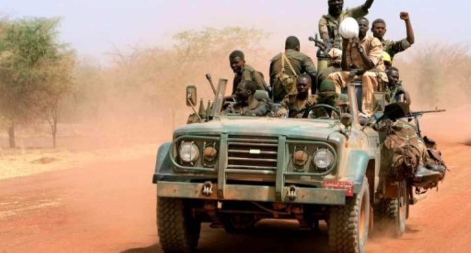 Sudanese soldiers ride in a military vehicle in the oil region of Heglig in April 2012.  By Ashraf Shazly (AFP/File)