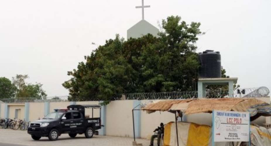 Soldiers and policemen guard a church in Maiduguri on May 13.  By Pius Utomi Ekpei (AFP/File)