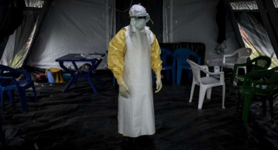 Suited up: A health worker gets ready to perform checks at an Ebola treatment centre in Beni.  By John WESSELS AFP
