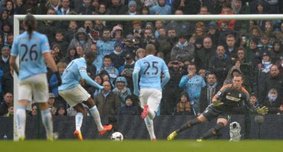 Yaya Toure 2nd left scores Mancheaster City's second goal during the 5-0 win over Fulham at the Etihad Stadium in Manchester, northwest England, on March 22, 2014.  By Paul Ellis AFP