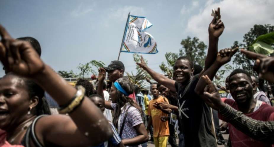 Supporters of Felix Tshisekedi celebrate after he was named winner of DR Congo's presidential election, while elsewhere supporters of Martin Fayulu took to the streets in protest.  By John WESSELS AFP