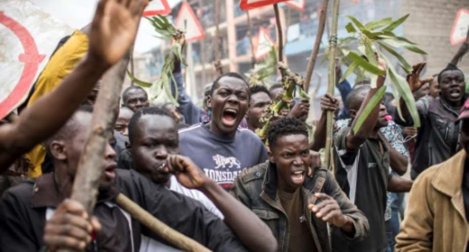 Supporters of Kenyan opposition presidential candidate Raila Odinga protest at the election results in Nairobi's Mathare slum.  By Luis TATO AFP