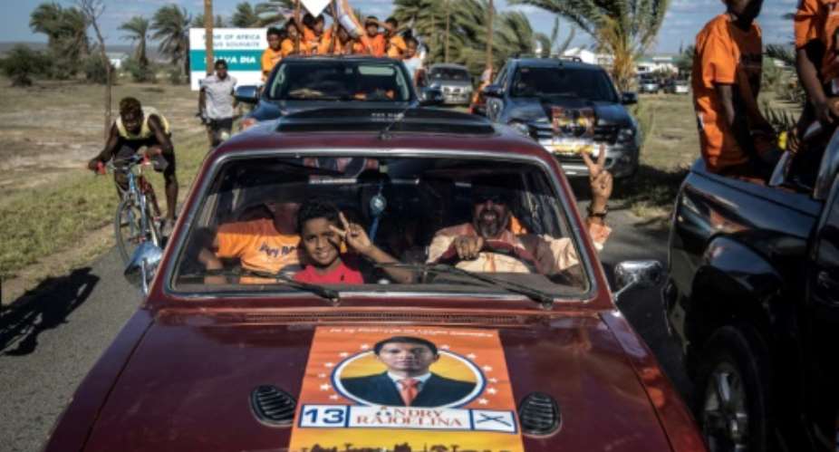 Supporters of Madagascar presidential candidate Andry Rajoelina celebrate as they go to a campaign rally in Tulear airport, on November 4, 2018. Former President Marc Ravalomanana and rival Andry Rajoelina are frontrunners in the November 7 ballot.  By MARCO LONGARI AFP