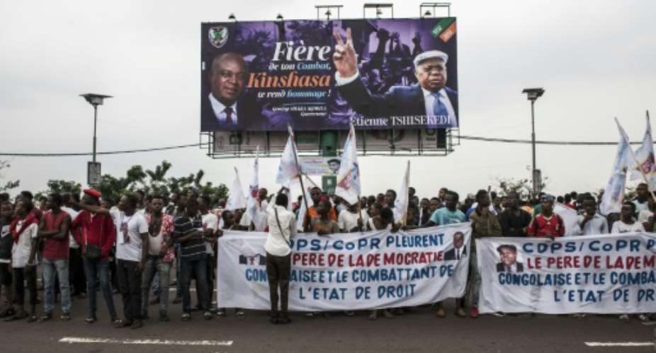 Supporters of the late Congolese opposition leader Etienne Tshisekedi outside the airport ahead of the arrival of his body.  By John WESSELS AFP