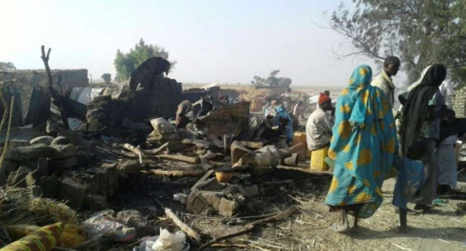 Survivors look at the aftermath of a bombing of a camp for displaced people by the Nigerian air force, in Rann, on January 17, 2017.  By  Mdecins sans Frontires MSFAFP