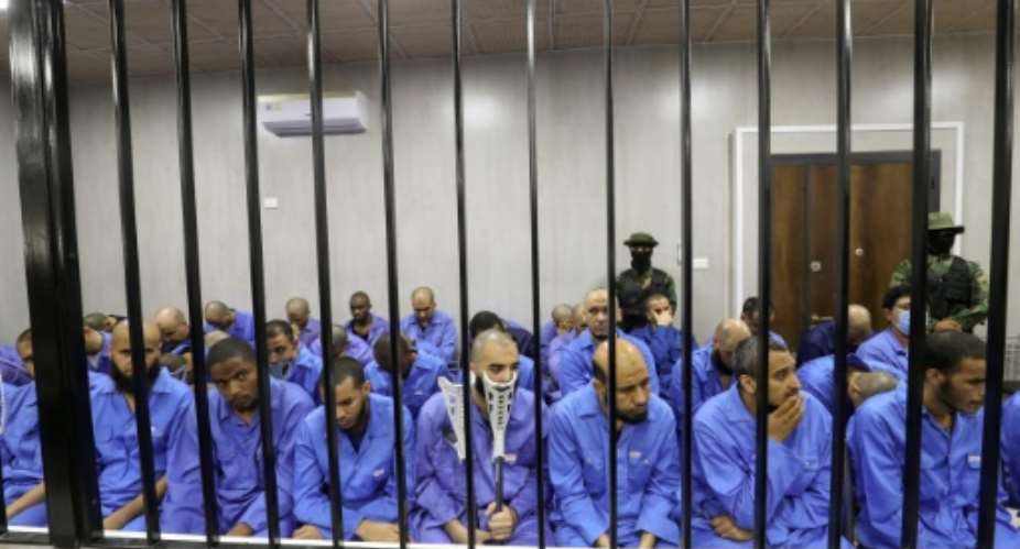 Suspected members of the Islamic State group sit in the dock during their trial in the western Libyan city of Misrata.  By Mahmud Turkia AFP