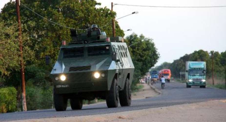 A police armoured vehicle escorts commercial trucks traveling from Muxungue in Sofala province on October 29, 2013.  By Ferhat Momade AFPFile