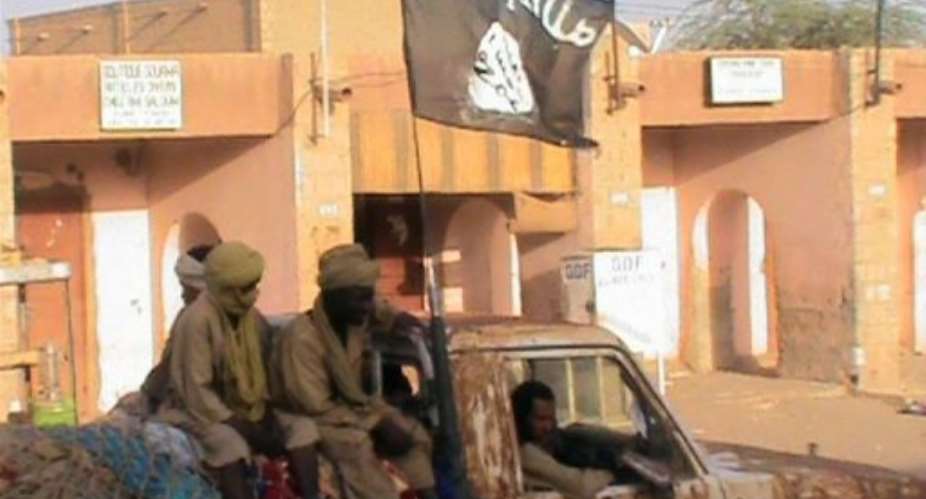 TV grab shows a pick up truck carrying supporters of the Islamist group Ansar Dine, on April 3, in Timbuktu.  By  (AFP/France 2)