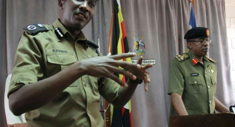 Taken on March 15, this photo shows Ugandan police spokesman Andrew Kaweesi L speaking to reporters in Kampala. On Friday, he was shot and killed as he left his home in Kampala.  By GAEL GRILHOT AFPFile