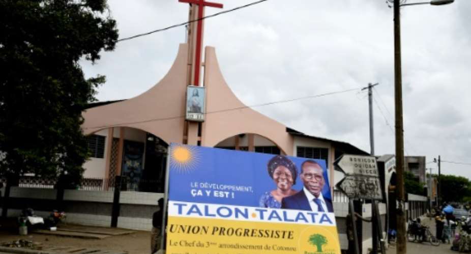 Talon, seen here in one of his campaign posters, is widely expected to win Sunday's election.  By PIUS UTOMI EKPEI AFP