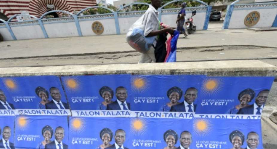 Talon, seen here with his running mate Mariam Talata on campaign posters in Cotonou, is expected to win on Sunday.  By PIUS UTOMI EKPEI AFP