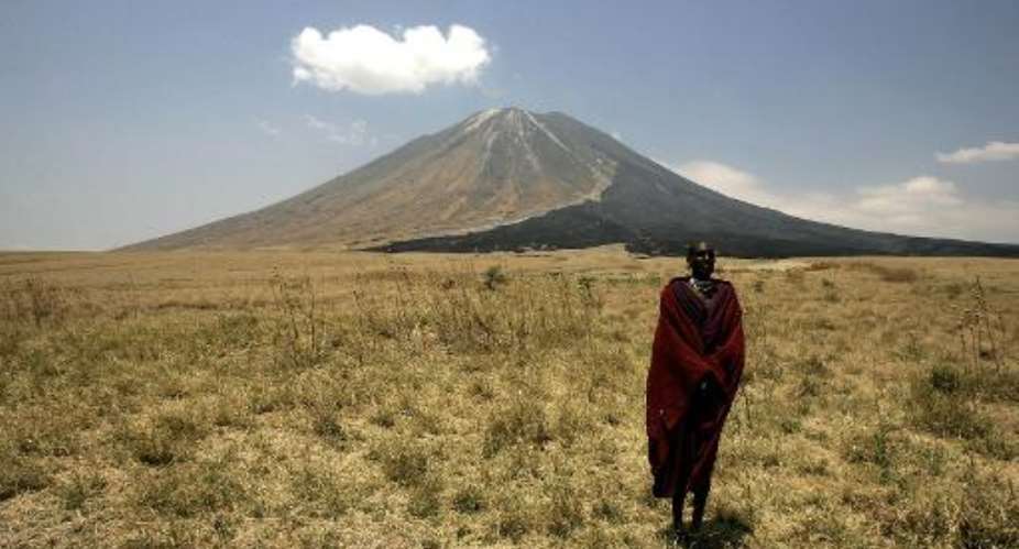 A Maasai tribesman stands on the slopes leading up to the Ol Doinyo Lengai volcano in the Ngorongoro Conservation Area, northern Tanzania.  By Joseph Eid AFPFile