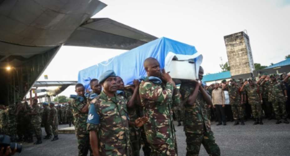 Tanzania People's Defence Forces soldiers carry the coffin of a peacekeeper on December 11, 2017 at the Ukonga Air Base in Dar es Salaam.  By - AFPFile