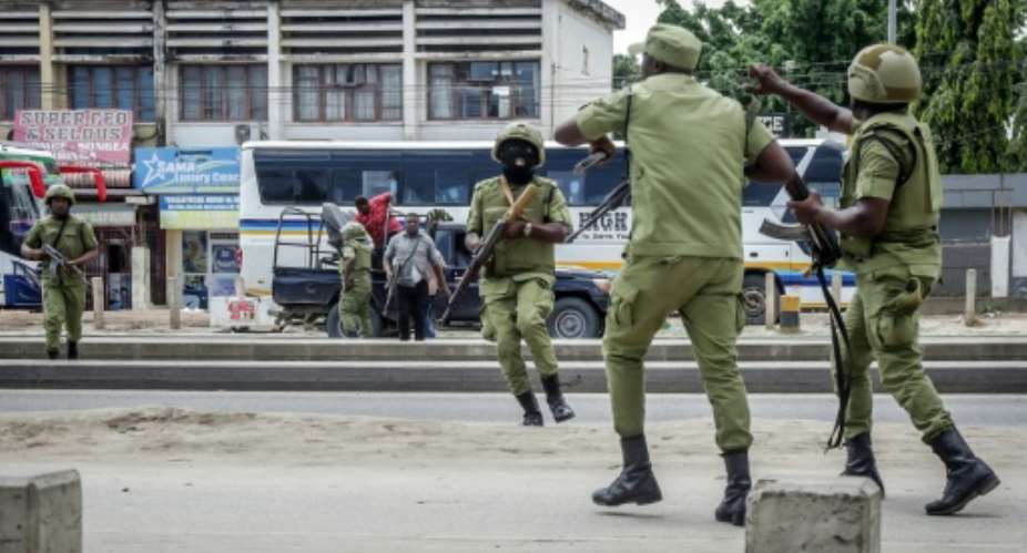 Tanzanian police officers try to disperse protesters on October 29.  By - (AFP)