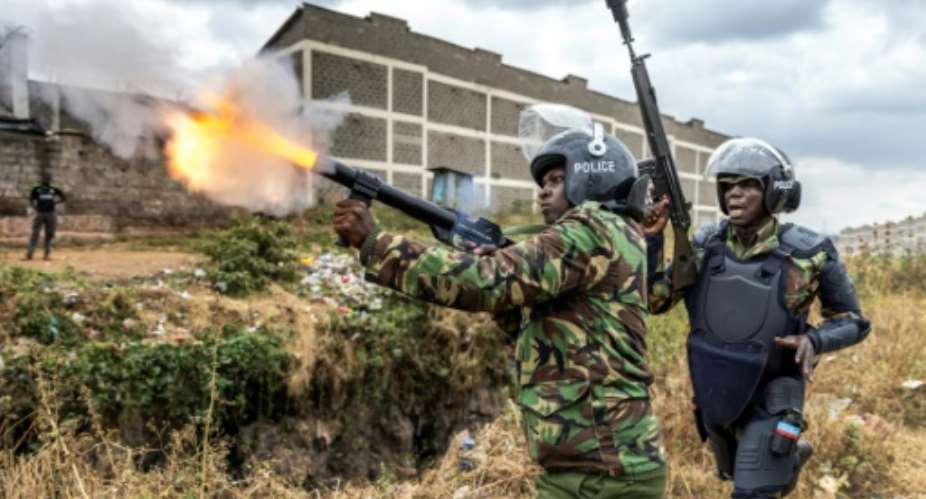 Tax demo: A police officer firing tear gas to disperse protesters in Nairobi.  By Luis Tato (AFP)