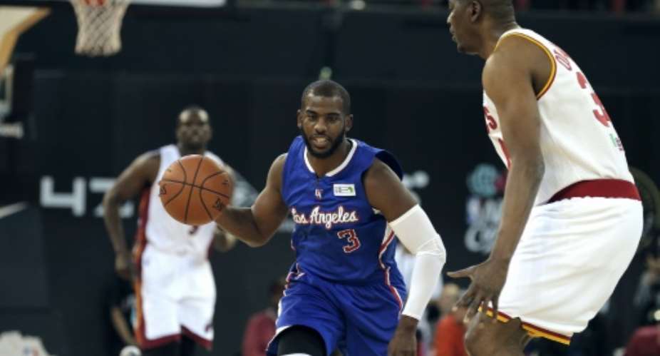 NBA Team World's US captain Chris Paul R of the Los Angeles Clippers dribbles the ball during the NBA Africa basketball match between Team Africa and Team World on August 1, 2015, in Johannesburg.  By Gianluigi Guercia AFP