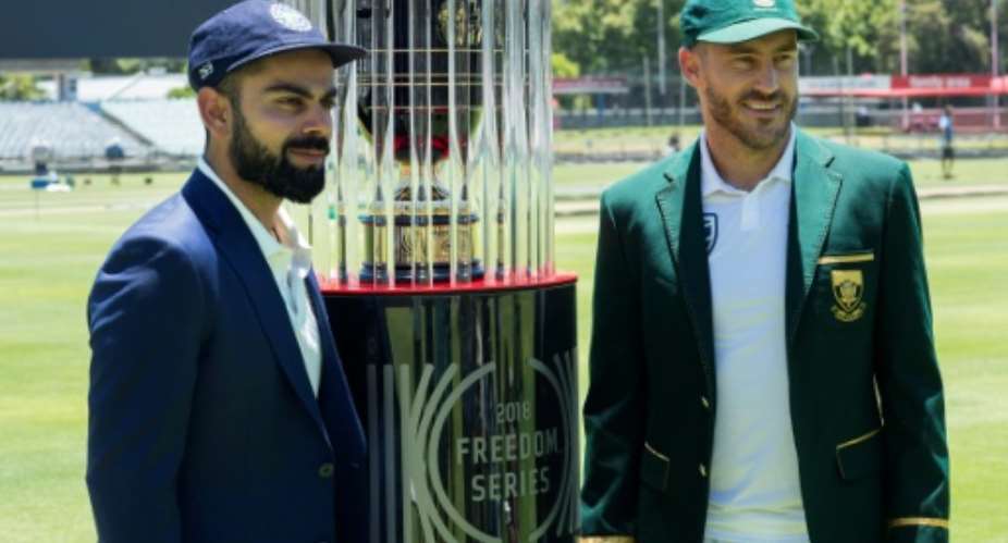 Teams' captains, India's Virat Kohli L and South Africa's Faf du Plessis, pose with the 2018 Freedom Series trophy, at the Newlands Cricket ground in Cape Town, prior to their Test match series, on January 3.  By RODGER BOSCH AFP