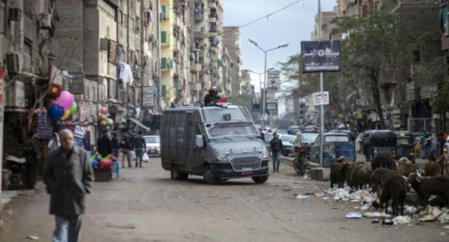 Members of the Egyptian police special forces patrol streets in al-Haram neighbourhood in the southern Cairo district of Giza on January 25, 2016.  By Mahmoud Khaled AFPFile