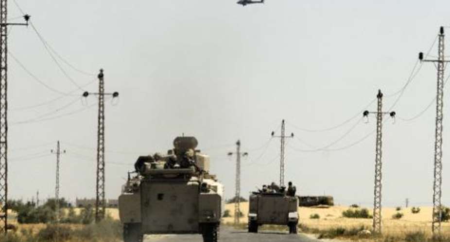 Egyptian soldiers and a military helicopter are deployed in the area of the Rafah Crossing border between Egypt and the Gaza Strip on May 21, 2013.  By  AFPFile