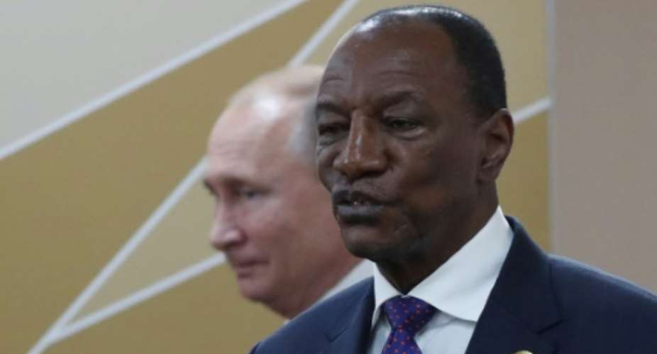 Tens of thousands of people have rallied in favor of Guinea's President Alpha Conde, pictured with Russian President Vladimir Putin October 24, 2019.  By Sergei CHIRIKOV POOLAFP