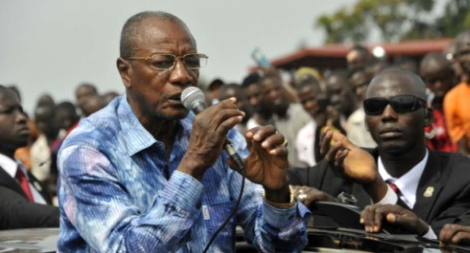 Guinea's President and presidential candidate Alpha Conde speaks at a rally reiterating his call for calm in Conakry on October 9, 2015.  By Cellou Binani AFP