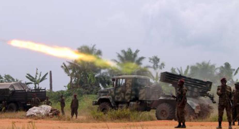 An armored vehicle of the Democratic Republic of Congo governmental troops, fires a missile during a fight against Ugandan rebels of ADF-Nalu, on January 18, 2014 near Kokola.  By Alain Wandimoyi AFPFile
