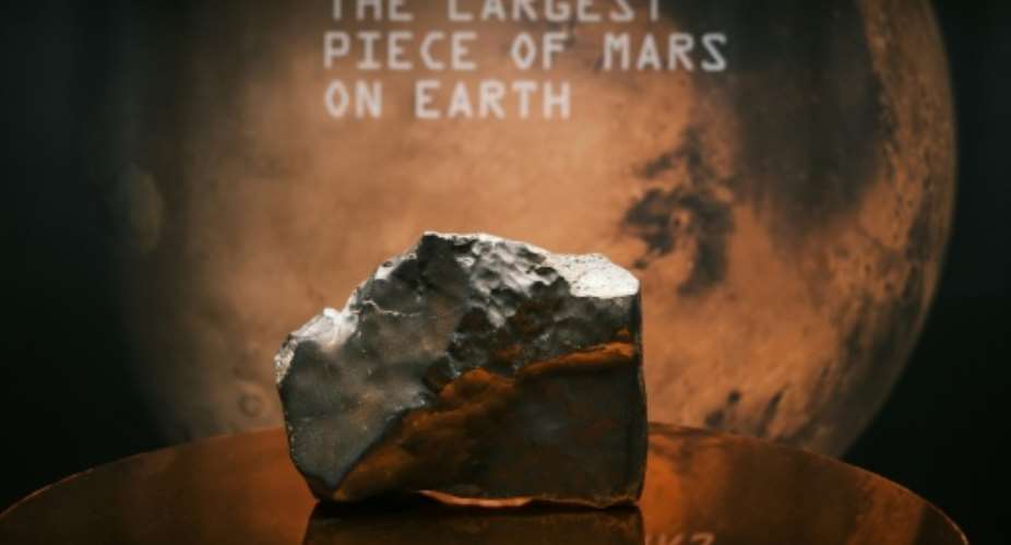The 54-pound Martian meteorite NWA 16788, the largest known piece of Mars ever discovered on Earth, was sold for a record $5.3 million at Sothebys New York.  By CHARLY TRIBALLEAU (AFP)