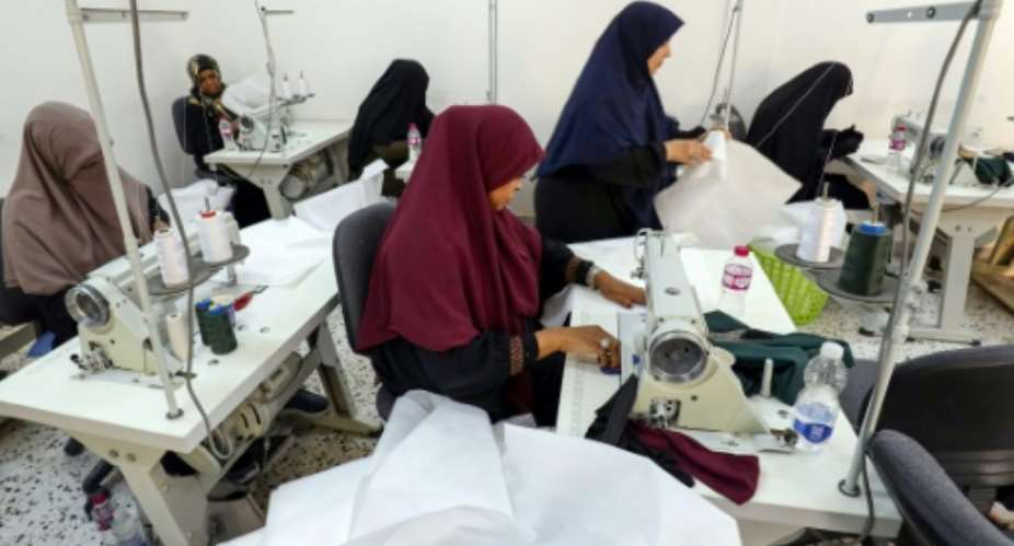 The apprentice dressmakers in Tripoli put their training on hold to help distressed survivors of the flash flood in Libya's east.  By Mahmud Turkia AFP