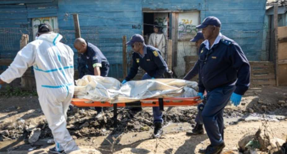 The attackers struck before midnight on Tuesday in an impoverished area of metal shacks near where illegal miners were living and working.  By EMMANUEL CROSET (AFP)