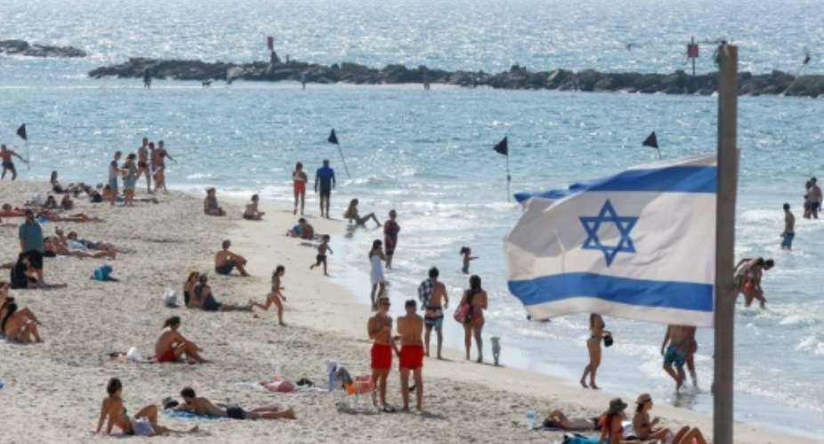 The beach in the Israeli coastal city of Tel Aviv reopened on Sunday as new infection numbers receded.  By JACK GUEZ AFP