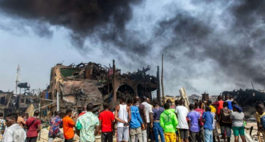 The blast destroyed buildings, lorries and cars.  By Benson IBEABUCHI AFPFile