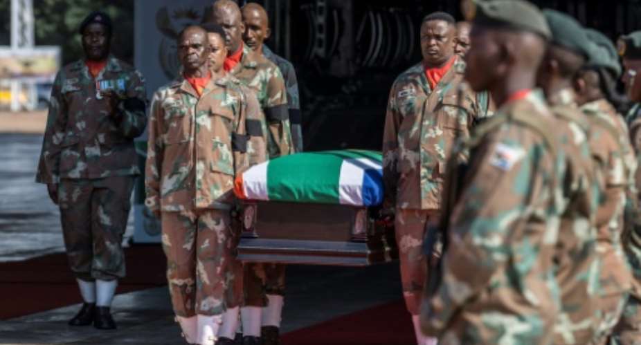 The bodies of two South African soldiers killed in a mortar attack in the Democratic Republic of Congo were given full military honours on their return home.  By MARCO LONGARI AFP