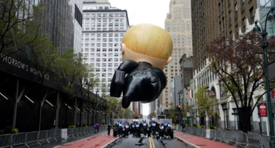 The Boss Baby balloon floats during an uncharacteristically subdued Macy's Thanksgiving Day Parade in New York on November 26, 2020.  By TIMOTHY A. CLARY AFP