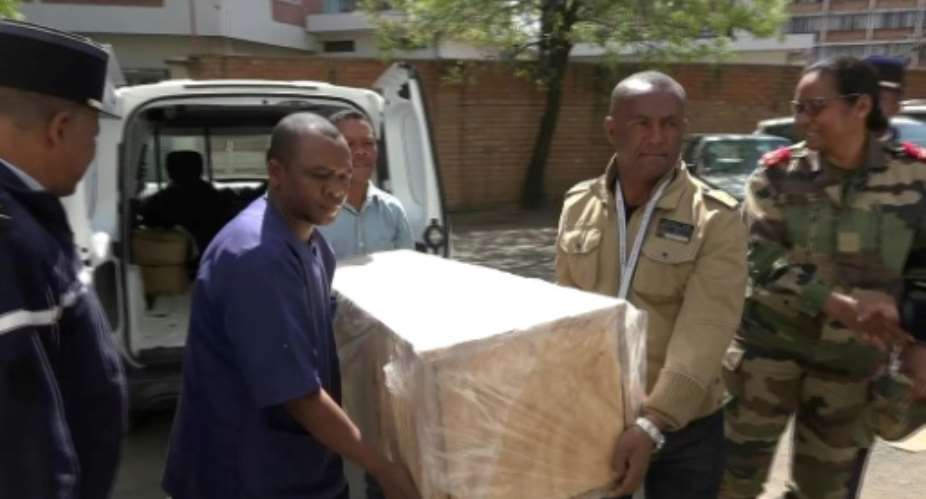 The coffin containing the remains of British Cambridge University student Alana Cutland was carried out from the morgue.  By Volana RAZAFIMANANTSOA AFP