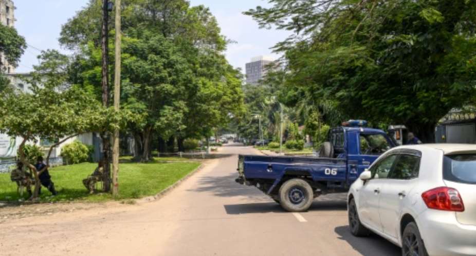 The Congolese Republican Guard and police block a road around the scene after the army said it had thwarted an attempted coup in the capital Kinshasa.  By ARSENE MPIANA (AFP)
