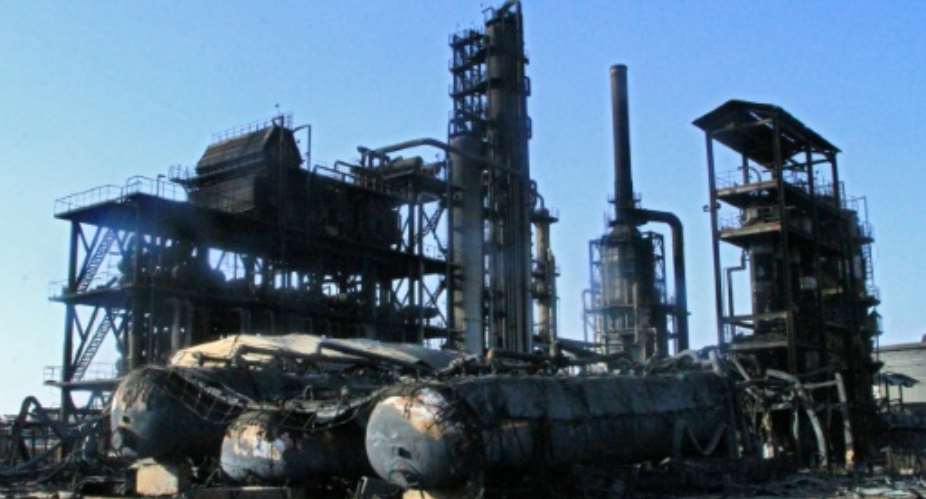The distillation tanks of Sudans biggest oil refinery lie blackened on the ground after it became a battleground in the devastating war between the countrys rival generals..  By Ebrahim Hamid (AFP)