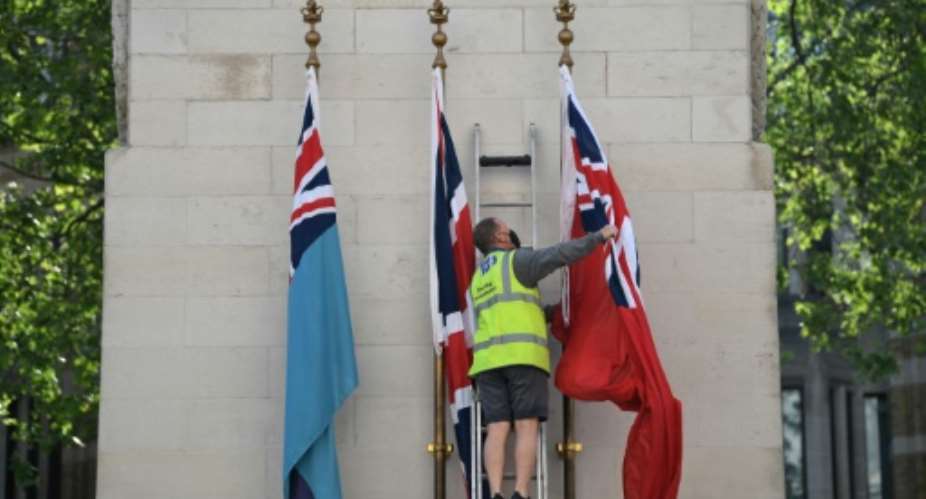 The flag of the Royal Air Force, Union Flag and the flag of Merchant Navy are raised on the Cenotaph war memorial in Whitehall, London.  By DANIEL LEAL-OLIVAS AFP