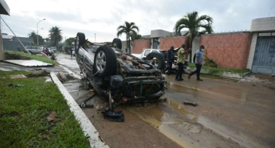 The floods in Ivory Coast's economic capital Abidjan flipped cars and destroyed houses, then were gone as quickly as they came.  By SIA KAMBOU AFP