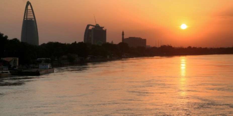 The Greater Nile Petroleum Oil Company GNPOC Tower and PetroDar Operating Company PDOC Tower left to right near the Blue Nile riverfront in Sudan's capital Khartoum at sunset.  By Ebrahim HAMID AFPFile