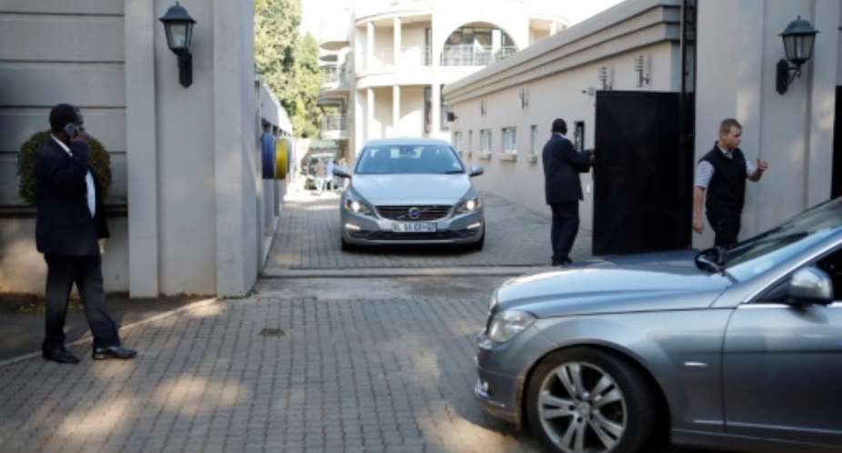 The Hawks police investigative unit and the tax service descended on the Guptas' heavily protected compound in the upmarket Johannesburg suburb of Saxonwold.  By WIKUS DE WET AFPFile