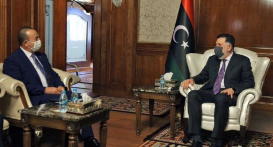 The head of Libya's UN-recognised Government of National Accord Fayez al-Sarraj R holds talks in Tripoli with Turkish Foreign Minister Mevlut Cavusoglu whose country backs the GNA in its fight against eastern-based Libya strongman Khalifa Haftar.  By - AFP