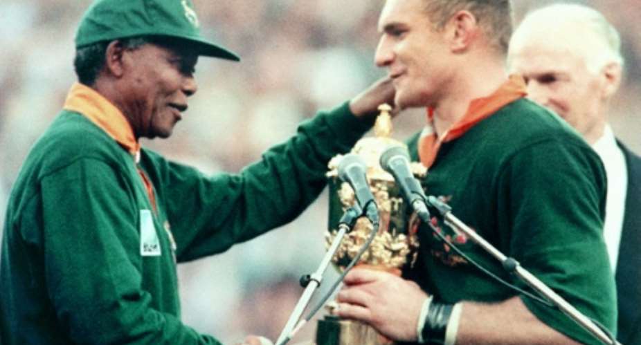The iconic picture of Nelson Mandela L congratulating captain Francois Pienaar after the Springboks won the 1995 Rugby World Cup.  By Jean-Pierre MULLER AFP