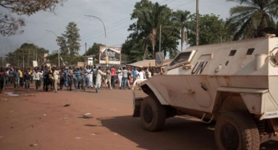 The inhabitants of the mainly Muslim PK5 neighbourhood demonstrate in front of the UN peacekeeping mission in the Central Africa Republic, in Bangui, on April 11, 2018; MINUSCA has backed CAR's request for Chinese weaponry.  By FLORENT VERGNES AFPFile