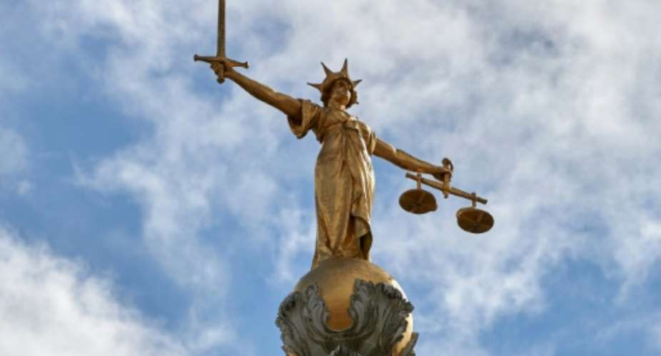 The Lady of Justice stands on the dome of the Central Criminal Court in London, commonly referred to as The Old Bailey, where a Ugandan woman was convicted of female genital mutilation.  By NIKLAS HALLE'N AFPFile